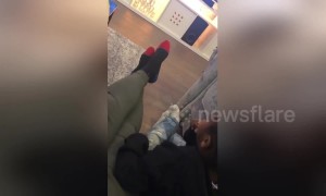 Adorable kid copies his dad's leg movements whilst watching TV