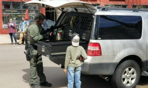 Young boy in awe as heavily armed police officer prepares for 'possible standoff' in Denver