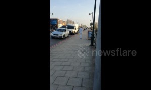 Enthusiastic man performs dance routine across Kew Bridge in London