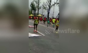 Bollards blown over by helicopter livestreaming Chongqing marathon race injure one runner