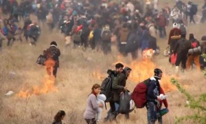 Refugees in Greece start fires as they clash with police in attempt to reach northern border