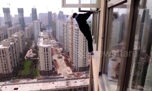 Robber tries to escape police climbing out of 22nd-floor window in China's Hunan