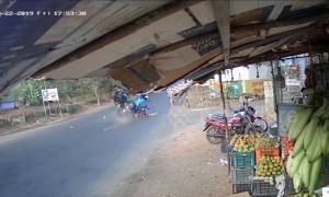 Horrific moment two mopeds smash together in the middle of a busy road