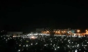 Thousands protest outside Sudan army HQ with phones in the air