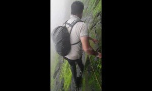 Trekker shows off terrifyingly slippery climb along cliff edge in west India