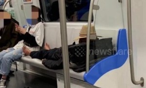 Old Chinese man sleeping barefoot on train seats attacks young man asking if he's well