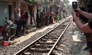 Train Passes Through Tiny Street in Vietnam