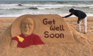 Sand artist in India carves 'Get Well' message for recently ill Dalai Lama
