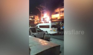 Fire rips through buildings as thousands of tourists splash water in Thai new year celebrations