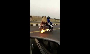Indian family rides down highway on burning motorbike
