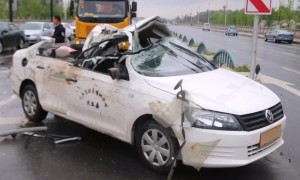 Out-of-control lorry slides into car and rips its roof off in China