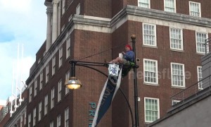 Man climbs lamppost in London's Oxford Street in climate change protest
