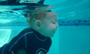 Baby incredibly jumps in and swims all the way across pool