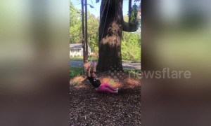 2-year-old falls off her swing in slow motion when dad pushes her