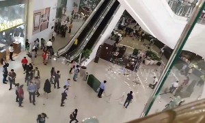 Debris plunges from fifth floor escalator as heavy rain batters Philippines shopping mall