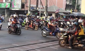 Motorcyclists risk their lives ignoring level crossing barrier as trains approach