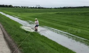 US man pulls off a 360 spin whilst wakeboarding in a flooded ditch