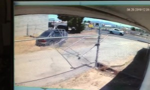 US driver fleeing police smashes through a business' fence to take a shortcut