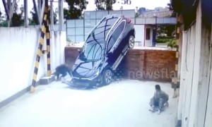 SUV driving off wall narrowly misses worker napping underneath