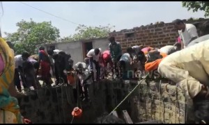 Indian families fetch water from 50-foot well in drought-hit village