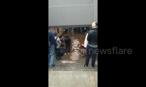 Russian commuters wade through flooded station in Moscow