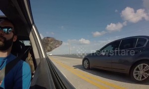 Rescue dog sticks head out of window and tries to bite cars as they pass