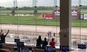 Crowds cheer on man running around course after storm cancels horse racing at Lonestar Park, Texas