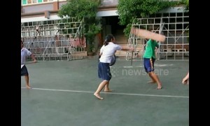 Thai students practice sword fighting during break time