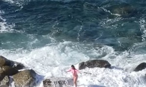 Wave Washes Away Posing People