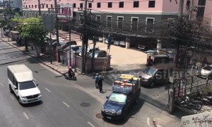 Health And Safety? Workers plant tall ladder In the middle of the road in Bangkok, Thailand