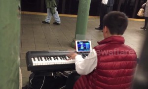 Child prodigy plays Mozart masterpiece while playing a computer game at the same time in New York, USA