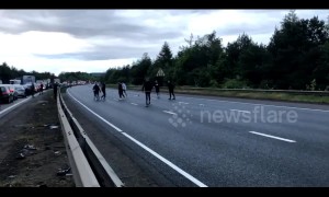 Football fans play kick-about during traffic gridlock on closed M1