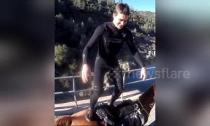 US man performs double front flip from horse's back off a bridge