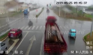Chinese moped rider slides out of path of oncoming lorry in amazing near-miss
