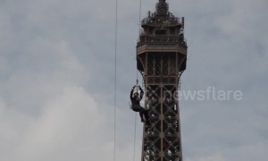 Brave thrill-seekers ride a 377-foot zipline off the Eiffel Tower