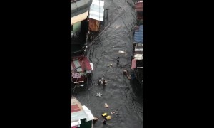 Locals rush to salvage possessions as rainy season floods hit the Philippines
