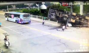 Men escape death after large crane flips over in China’s Jiangxi