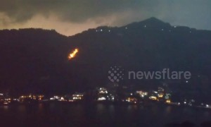 Lightning strike from storm ignites forest floor in India