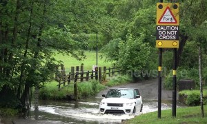 UK drivers cross flooded road in Birmingham despite warnings