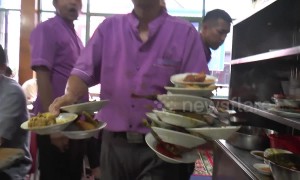 Talented waiter carries 17 food-filled plates at once in an Indonesian restaurant