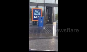 Funny moment man in leopard print gown walks out of Aldi with crate of beer