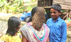 Indian woman covers face with hundreds of bees to create buzz for conservation
