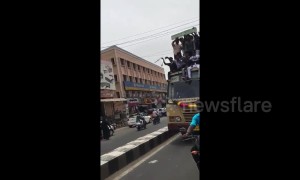 Terrifying moment celebrating students fall from top of moving bus in southern India