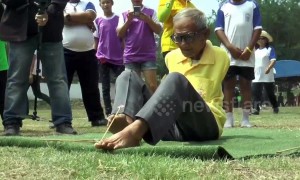 Thai pensioner born without arms has bizarre talent for firing crossbows with his FEET