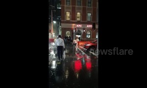 Man attempts to 'fight' rain while standing in the middle of a road in Sydney