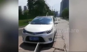Chinese couple escape injury after broken water pipe impales car