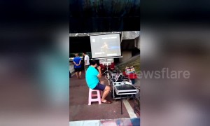 Man sets up outdoor karaoke stall under riverside bridge in China's Yichang