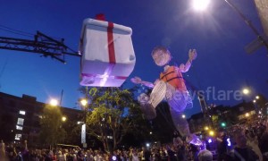 Giant puppet walks down road in East London