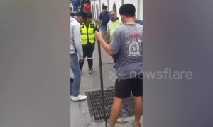 Bungling 'drug dealer' rescued by police after getting stuck in drain during chase