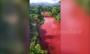 Discharged waste from mills in China's Yulin turns nearby river red